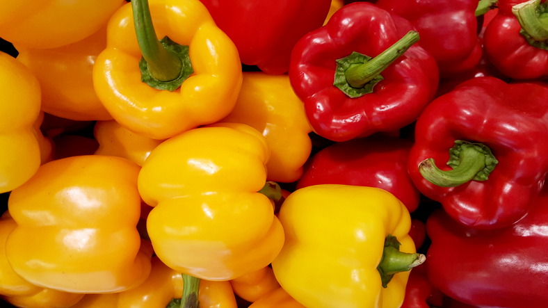 Red and yellow bell peppers background photo
